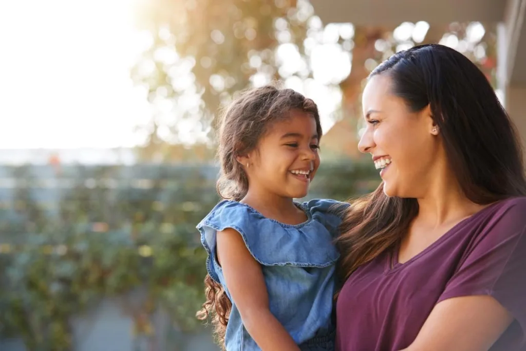 Woman holding child and benefiting from a family therapy program for addiction