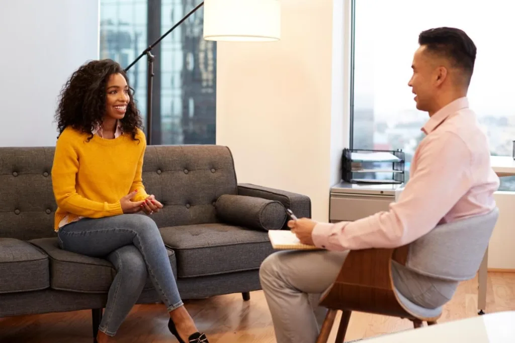 Two people talking in an outpatient rehab in Denver